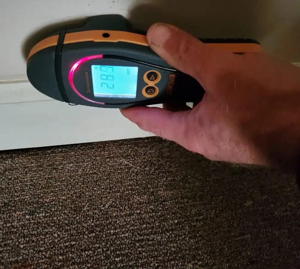 Moisture detection at baseboard during Storm Damage Restoration in Atlas
